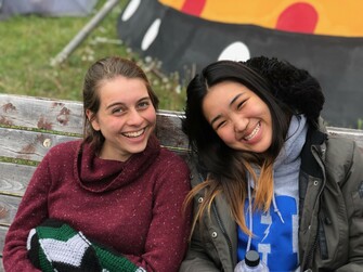 Two smiling girls enjoying each other's company